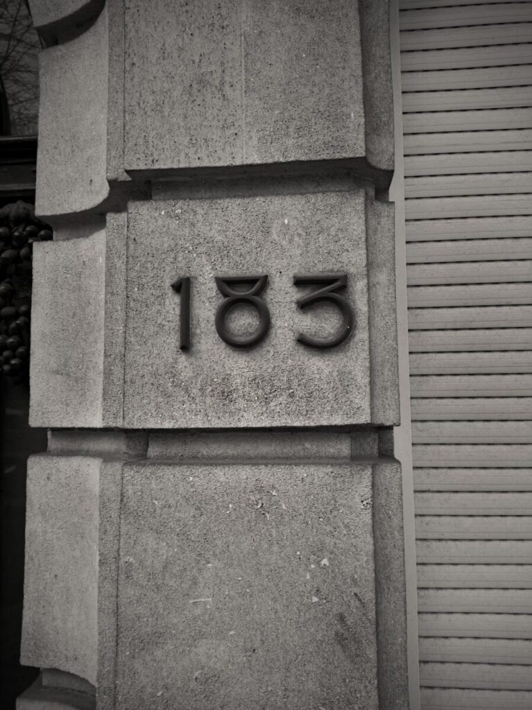 A black and white photo of a building with a number on it